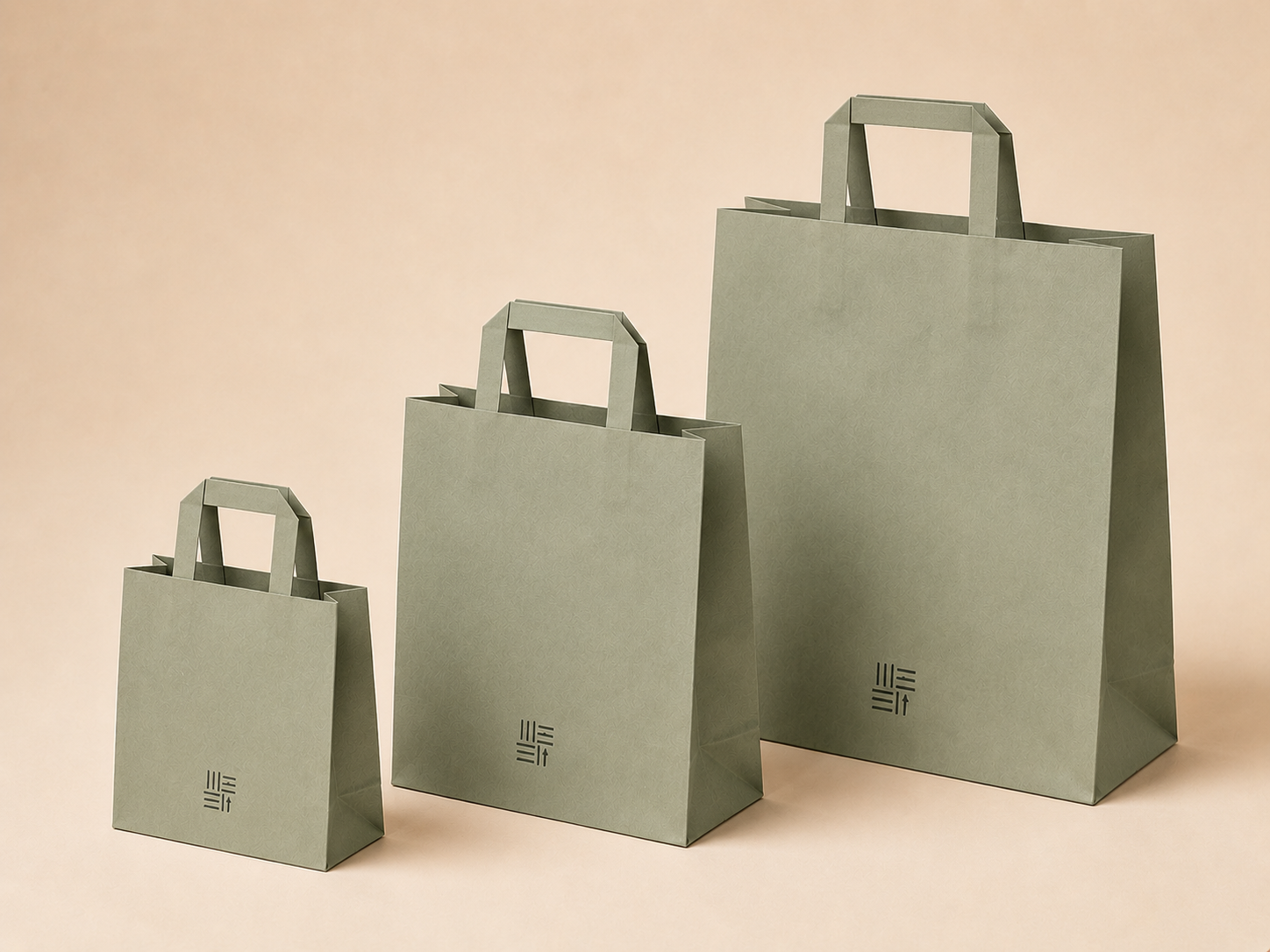 Sage green folded-handle paper bags in three sizes