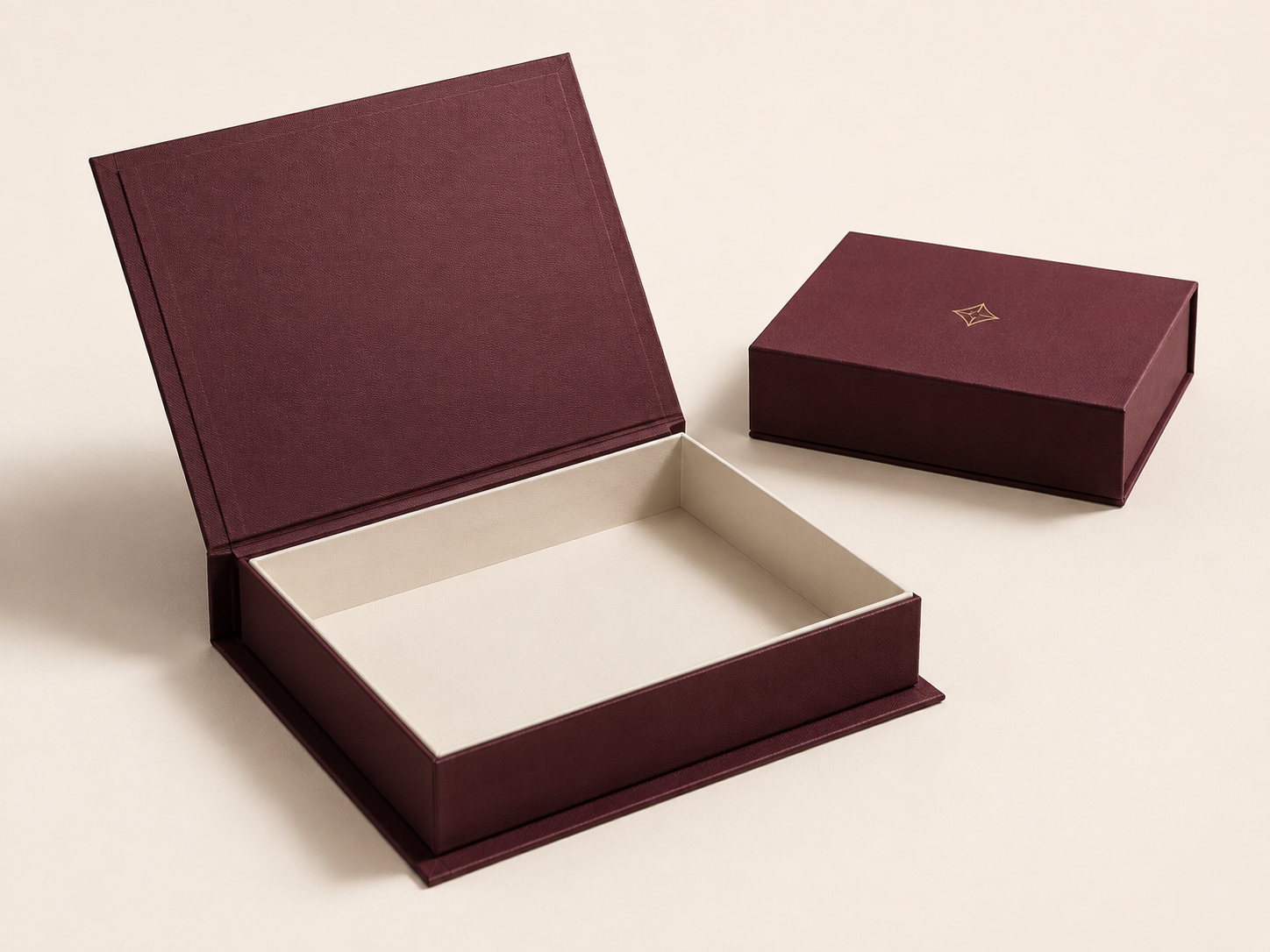 Burgundy hinged presentation boxes shown open and closed